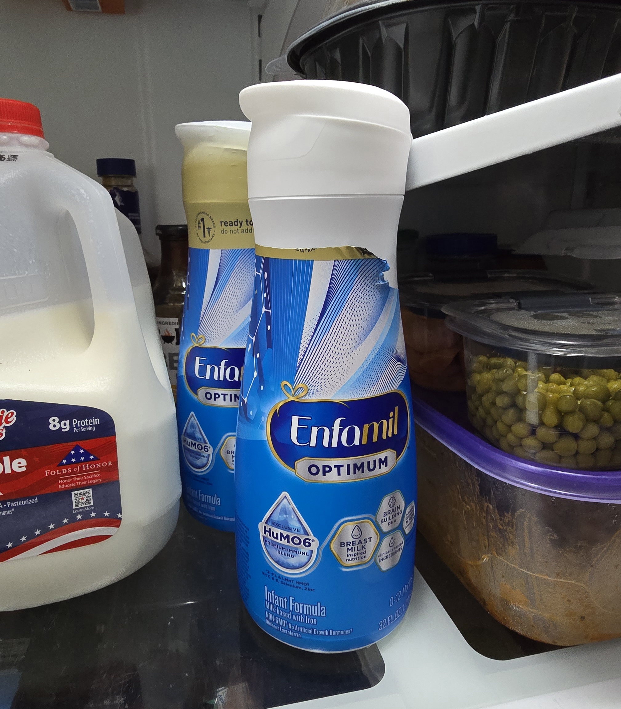 Close-up of Enfamil Optimum bottle resealable cap and expiration label detail