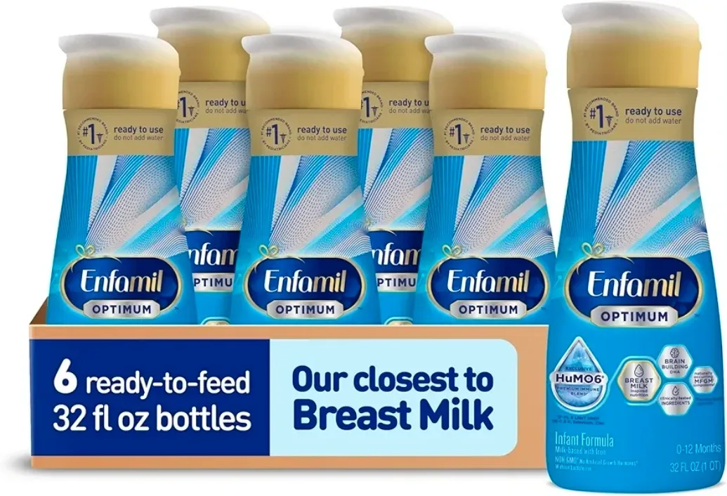 A six-pack of Enfamil Optimum Enspire RTF 32 fl oz bottles stacked on a home pantry shelf.