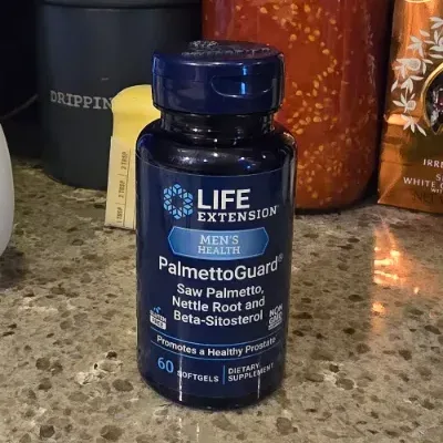 PalmettoGuard bottle next to a small stack of dollar bills on a clean neutral countertop