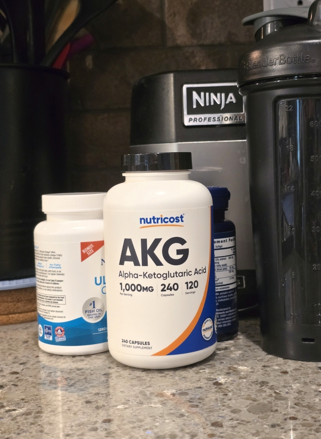 Nutricost AKG supplement bottle open on a kitchen counter with a glass of water in warm morning light