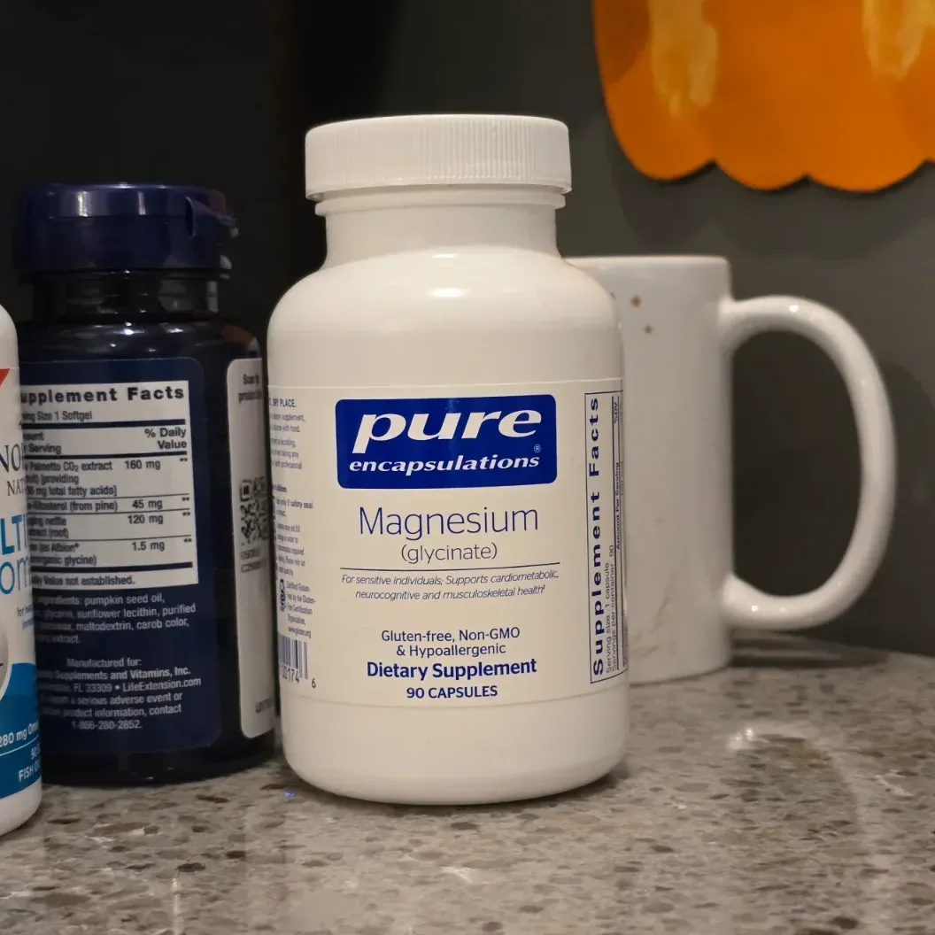White Pure Encapsulations supplement bottle displayed on a clean slate surface with soft natural lighting