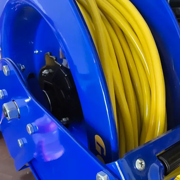 Extension cord retracting smoothly into the enclosed spring-driven reel mechanism on a garage wall