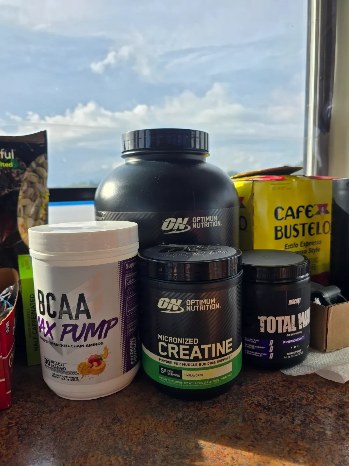 Clear shaker bottle with dissolved creatine powder sitting next to a measuring scoop