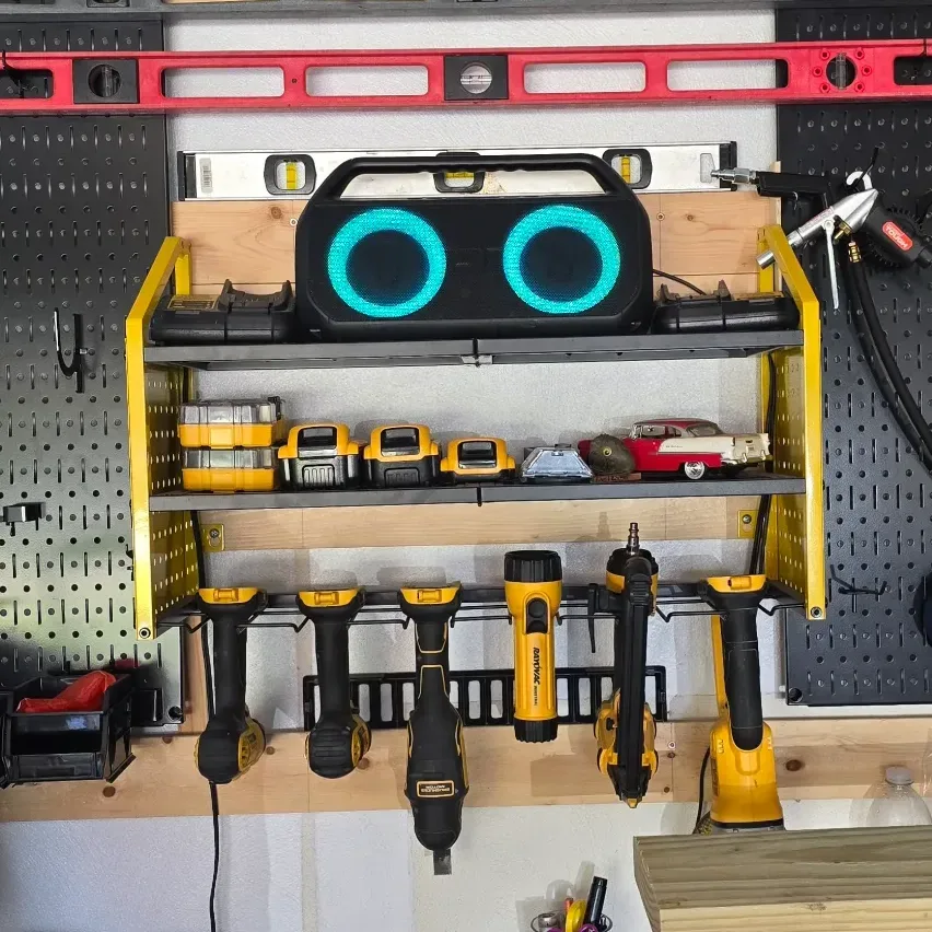LBT power tool organizer mounted on garage wall showing built-in 6-outlet charging strip and steel shelves.