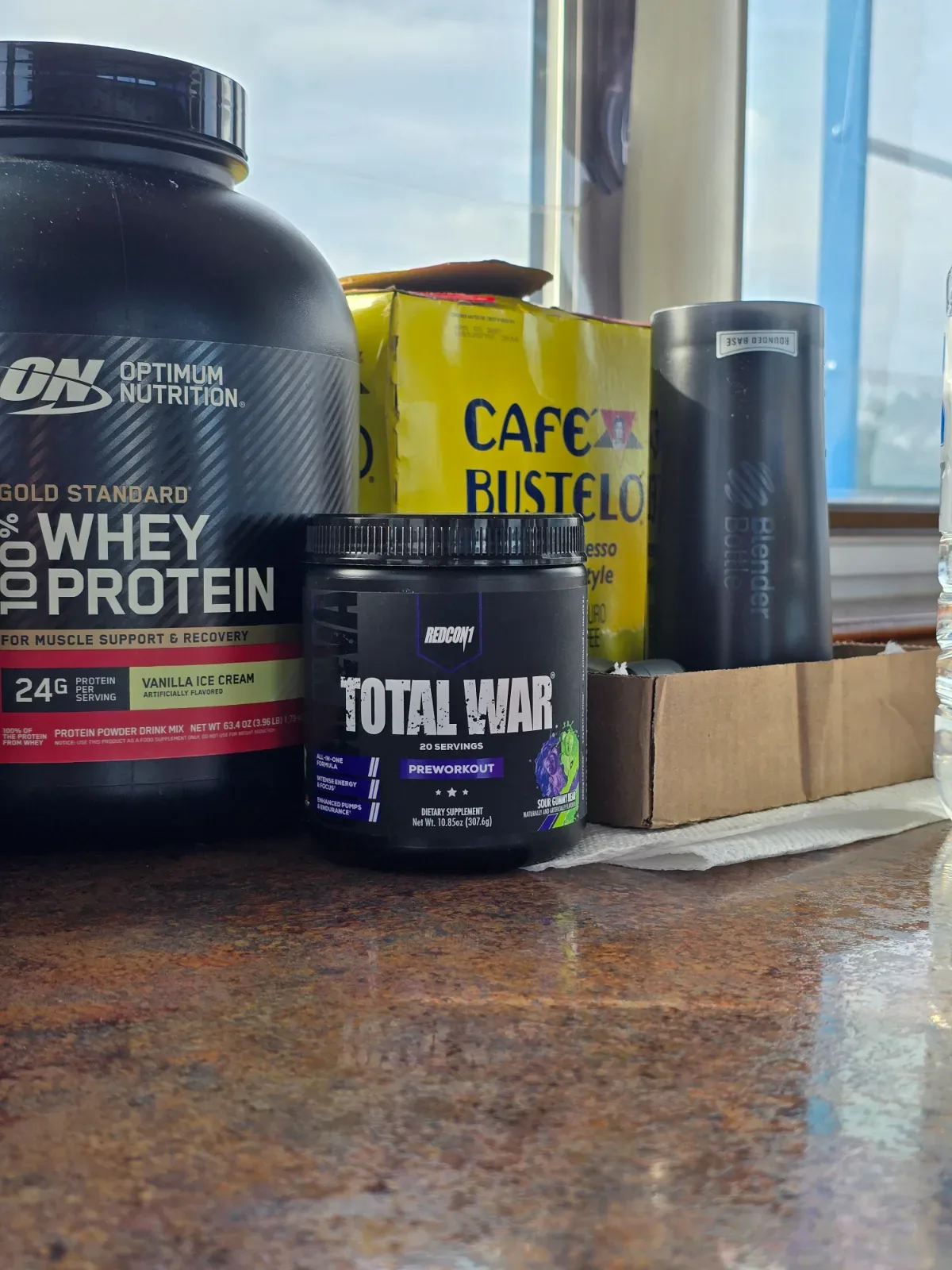 A protein shaker bottle sitting on a stainless steel surface aboard a working boat