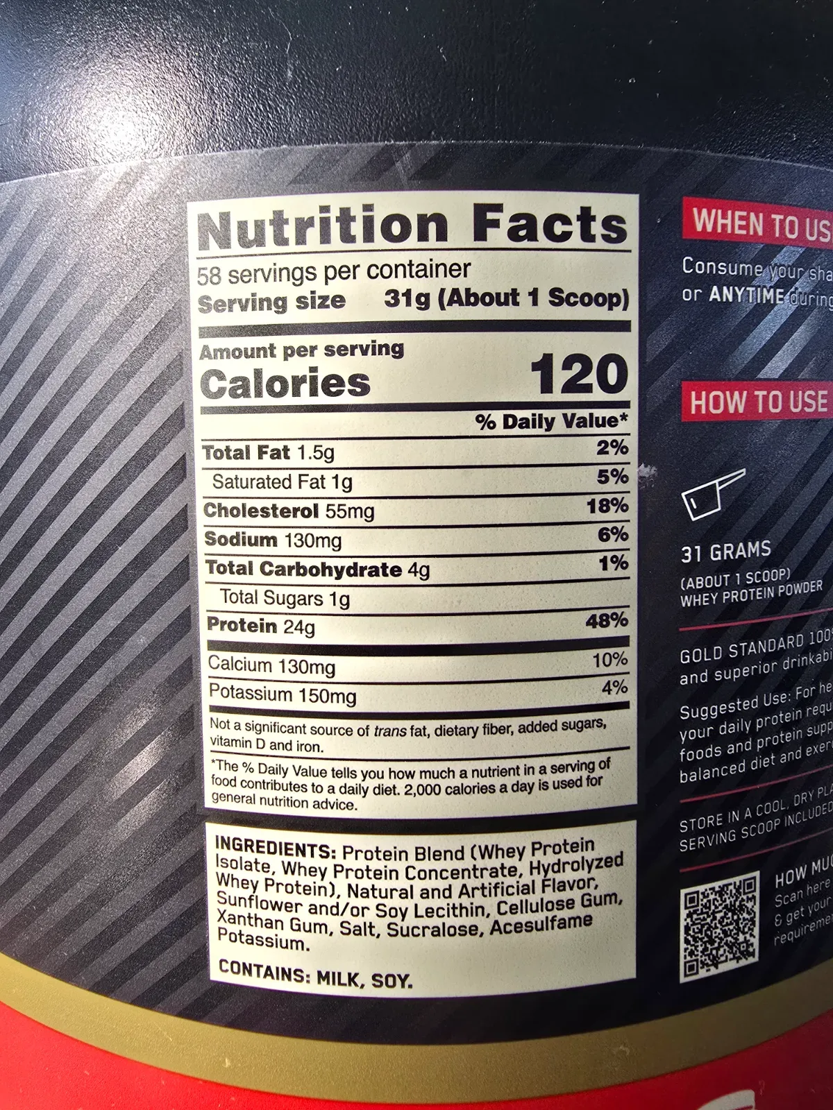 A rounded scoop of whey protein powder resting beside a shaker bottle on a counter